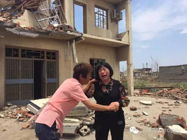 薛金林的养母（右）和婆婆在被龙卷风损坏的房子前痛哭。新京报记者王贵彬 摄