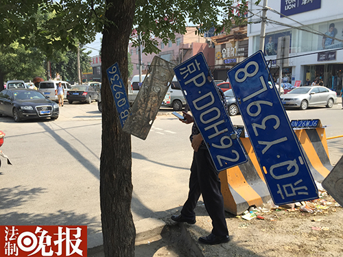男子在摆车牌赚外快