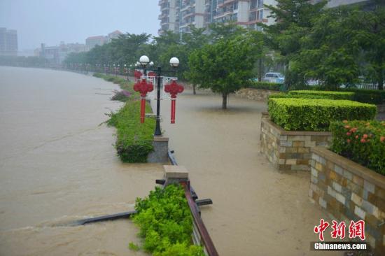 8月18日，2016年第8号台风“电母”给海南带来强暴雨天气，致海南省多市县出现严重内涝。在海南西部的临高县大部分道路积水严重，车辆无法通行，穿县城而过的文澜江滚滚洪水漫过江堤，低洼路段已被洪水吞没。 中新社记者 骆云飞 摄