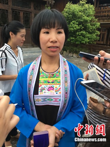罗嘉梅身着民族服饰接受采访