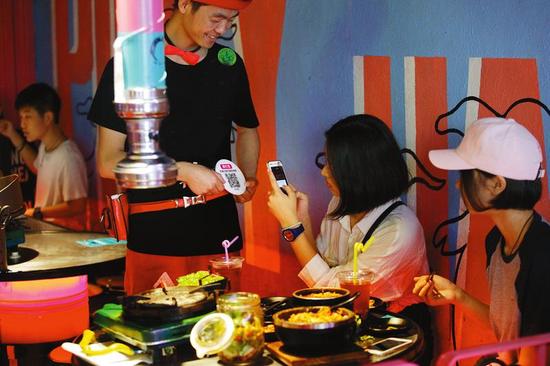 西安餐饮业兴起扫二维码“打赏”感谢服务员，市民对此褒贬不一 记者王晓峰摄
