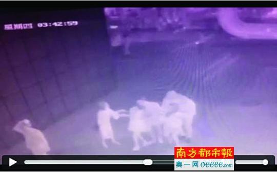 涉事男子从后面抱住了一名女子，右手伸入女子裙子里，左手在女子身前抚摸。监控截图。
