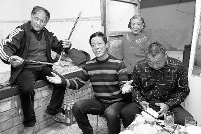 王力军和乡亲在饭桌上高兴地唱起了歌