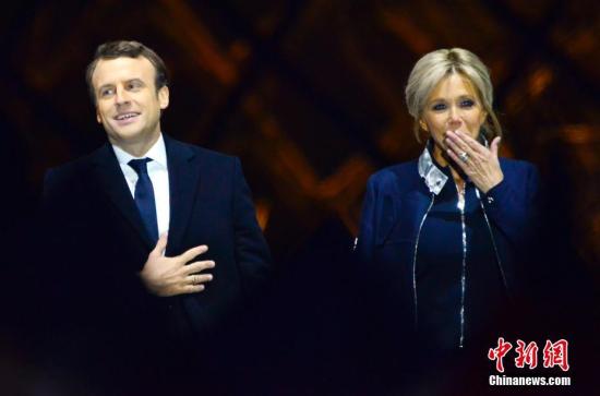 马克龙和妻子布丽吉特在巴黎卢浮宫前举行的庆祝胜选集会上。 中新社记者 龙剑武 摄