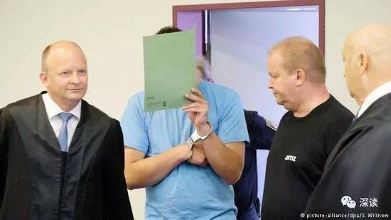 男被告用文件盖住脸，据媒体报道其全程无悔罪心情
