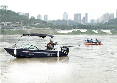 昨日，马桑溪大桥下江边，多支民间救援队对滑入江中的车辆进行搜寻。 本报记者 李斌 摄