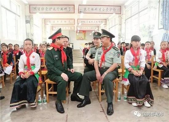 9月24日上午，范长龙与吴春历在金水河口岸边境小学交谈。（国防部官方微信）