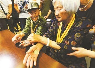 张道干和杨美田向侵华日军南京大屠杀遇难同胞纪念馆捐赠收藏70多年的3块银元和张道干在朱家岗战斗中缴获的一枚日军奖章