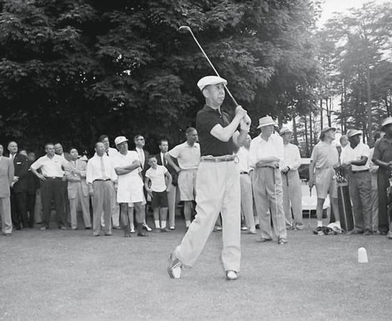 1957年，时任日本首相岸信介（前）访美时与美国总统艾森豪威尔（后排前戴帽者）一起打高尔夫球 资料图