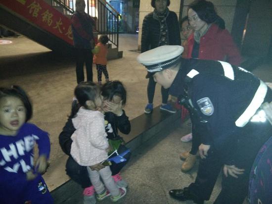 民警一边抱着孩子安抚，一边急救甄女士苏醒。