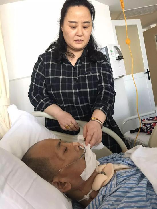 在湘雅二院病房，贺常红正在照顾患有口腔癌的丈夫敬思军，敬思军刚刚接受了第二次手术。新京报记者王婧祎 摄