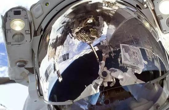 医生也爱自拍：第一次出舱行走时，宇航员罗伯特 小撒切尔用数码静态相机拍摄自己的头盔面罩。
