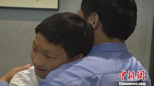 图为小雨和李存柱紧紧相拥。 史成燕 摄