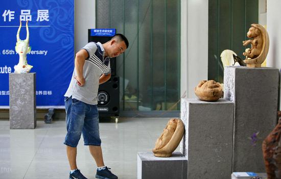 学生参观雕塑作品《江格尔十二勇士》。