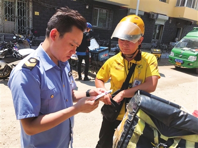 执法人员对网络外卖平台从业人员情况进行检查。