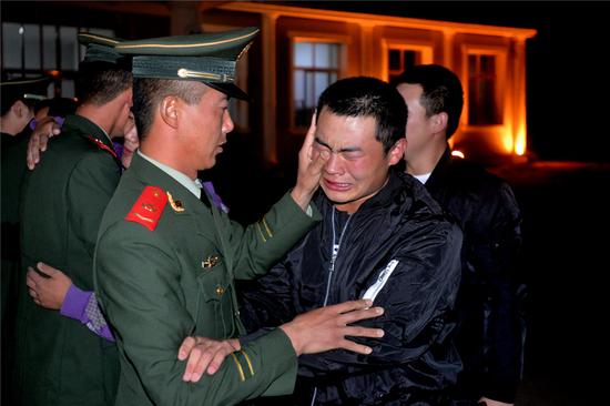 图为 官兵挥泪拥别