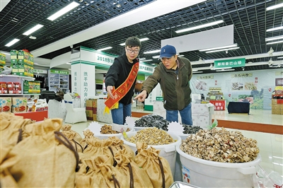 北京市民在展位前选购商品。