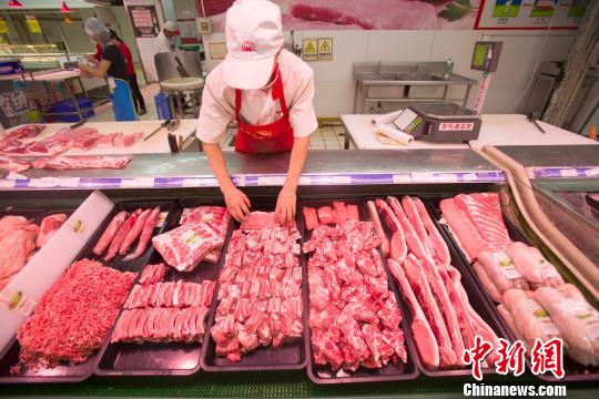 资料图:山西太原,超市员工在整理猪肉。张云 摄