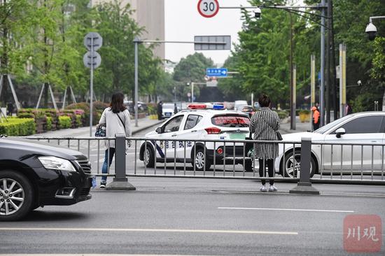 横跨护栏穿越益州大道的行人