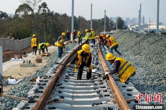 成自宜高铁成都双线特大桥至天府站区间工人们正在铺设轨道。　刘忠俊 摄
