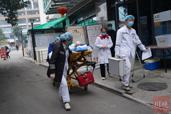 1月4日13时36分，彭沙从金牛区荷花池社区卫生服务中心接回一名老人，送上救护车。魏冯 摄