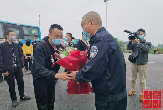 丹棱县副县长、公安局长曾贤清（右二）为参战民警送上鲜花