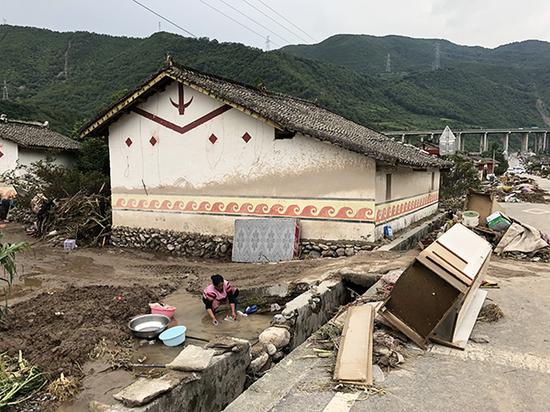 山洪后,村民將家具搬出,放在路邊晾曬。