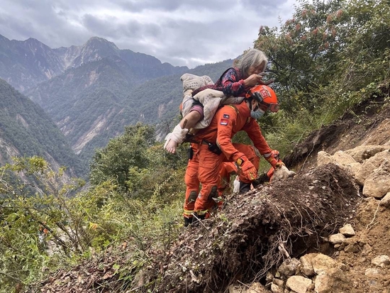 消防员跋山涉水转运伤员