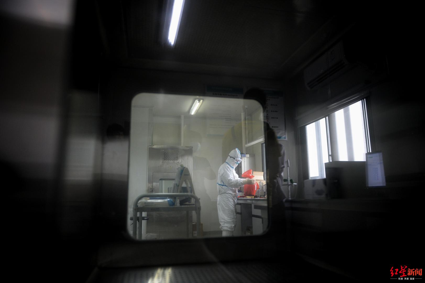 ↑核酸检测员在实验室打包处理实验垃圾