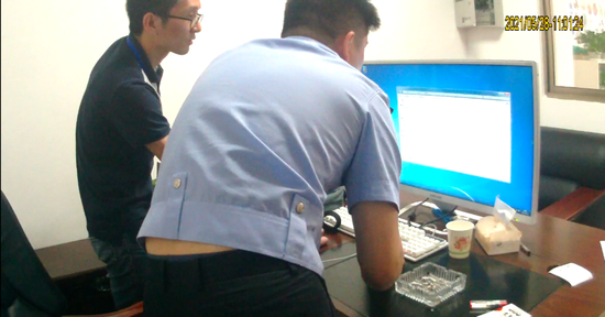 警方对涉案公司电脑进行检查。