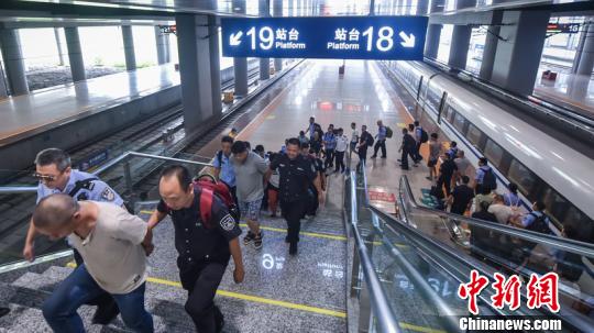 图为民警将犯罪嫌疑人押解回重庆。警方供图