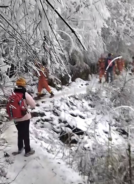 黄女士下山时遇到上山救援的消防员。受访者供图