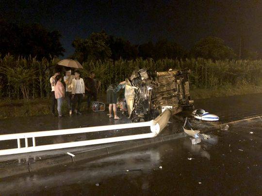 雨夜轿车撞倒路灯后侧翻