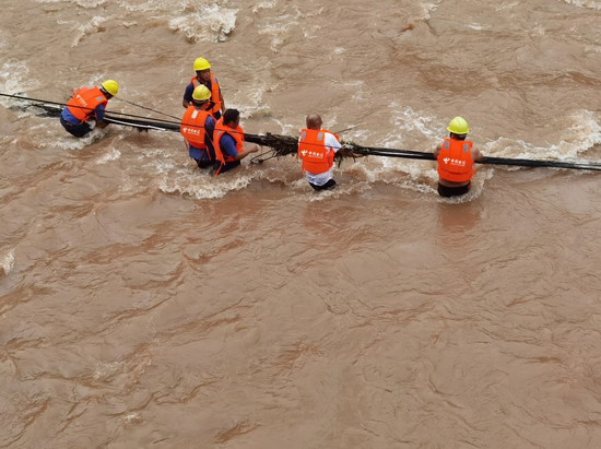 在大邑，成都电信抢险人员在洪水中抢修光缆线路