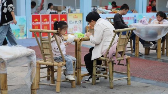 市民在现场的桌椅上吃饭休息