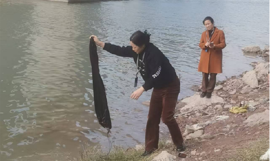 翠屏街道工作人员对违法垂钓的鱼进行放生