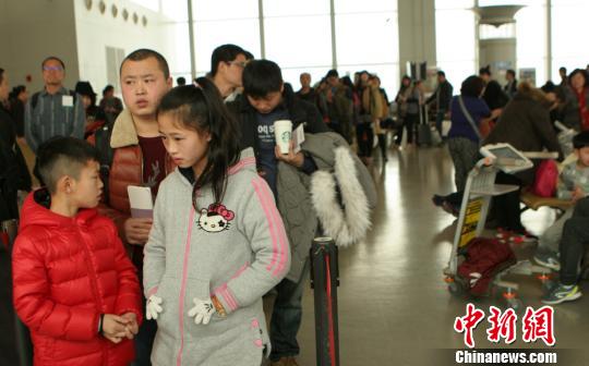 图为旅客排队通过安检。 吕俊明 摄