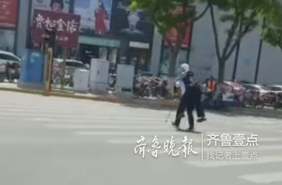 公交车司机见斑马线红灯即将亮起,背起老人快步将其送到安全位置。