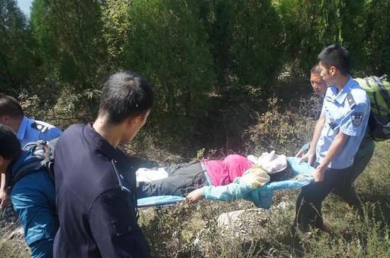 為防止雜草樹枝劃傷傷者,民警專門用衣物遮住了她的面部