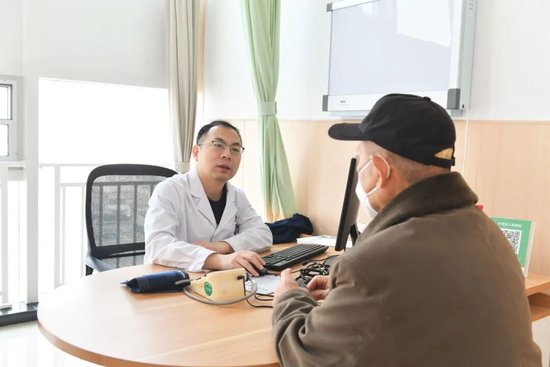 （图中为心内二科副主任医师赵洪光，正在为心脏支架患者复查）