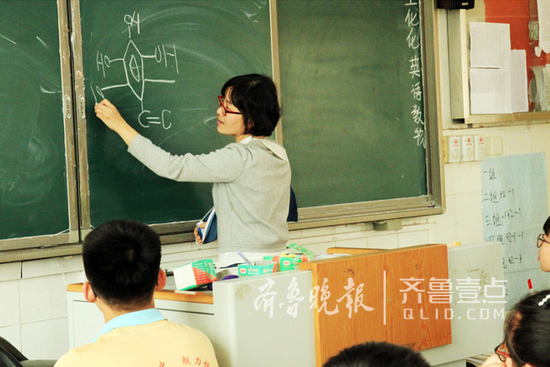 洪秀英老師用左手寫板書。