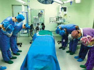 医务人员向捐献器官的女婴默哀。图片来自云南网