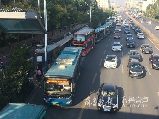 21日早上8点，在济南经十路与山师东路附近的公交站牌，进站的公交车排着长龙，即停即走，快捷方便。