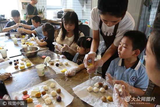 9月24日，济南，来自山东师范大学附属小学一年级六班的孩子们，与父母一同体验制作手工冰皮月饼，感受传统文化。