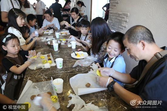 9月24日，济南，来自山东师范大学附属小学一年级六班的孩子们，与父母一同体验制作手工冰皮月饼，感受传统文化。