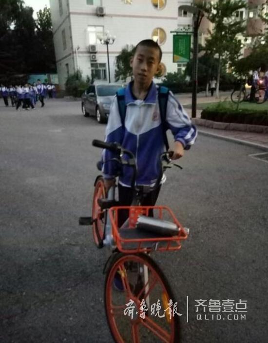 晚上放學的時候,該校初二九班一個男生,搬著一輛摩拜前行。