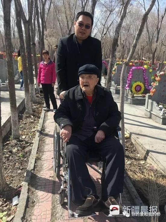 (趙寶學老人坐輪椅給父母掃墓)