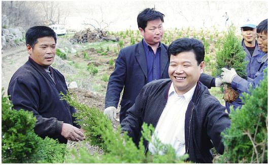 孙建博(左三)与林场职工一起参加绿化劳动。