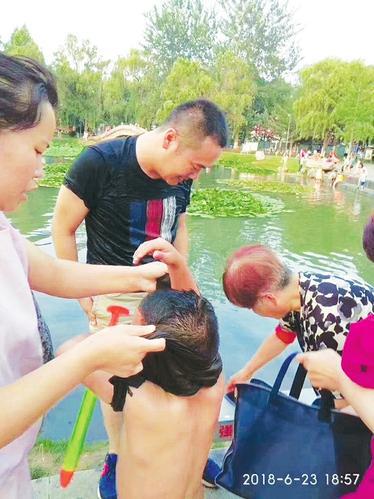 王曉(中)將男童救上岸。 本報通訊員攝