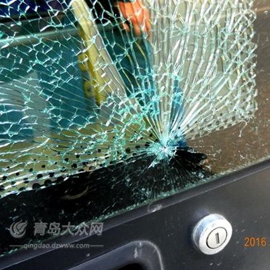 公交车前门玻璃上发现钢珠弹孔。